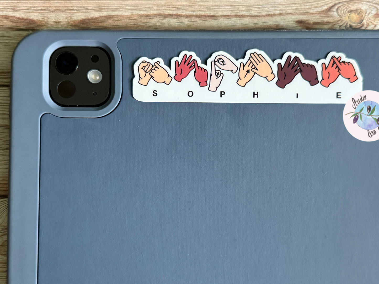 Sticker with hands and letters spelling Sophie in BSL (British Sign Language) on a tablet device, iPad
