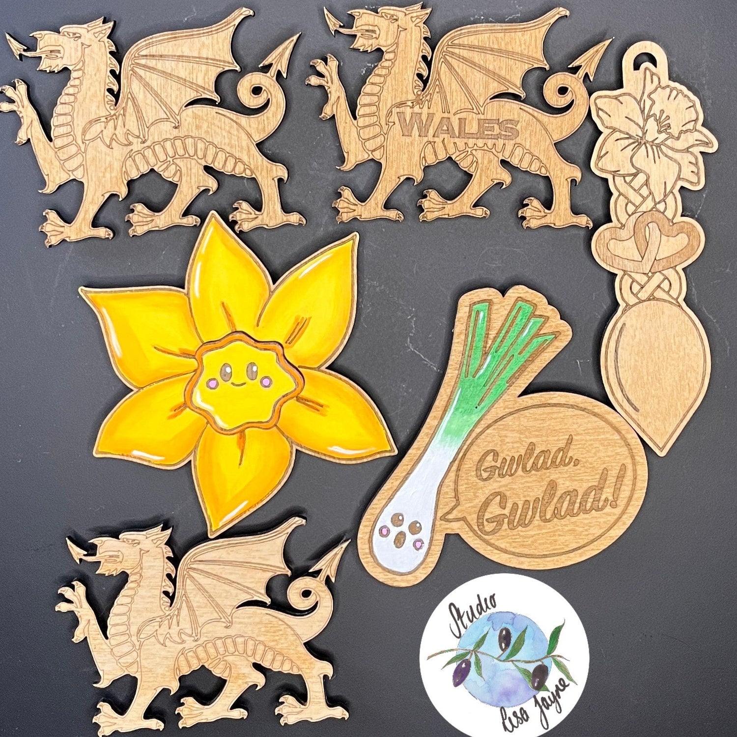 Collection of Handmade Welsh magnets including a leak singing Gwlad Gwlad, dragon, daffodil and lovespoon