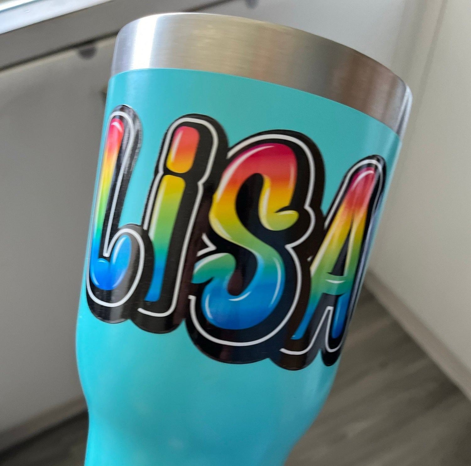 Rainbow Graffiti Name Sticker on a drink bottle