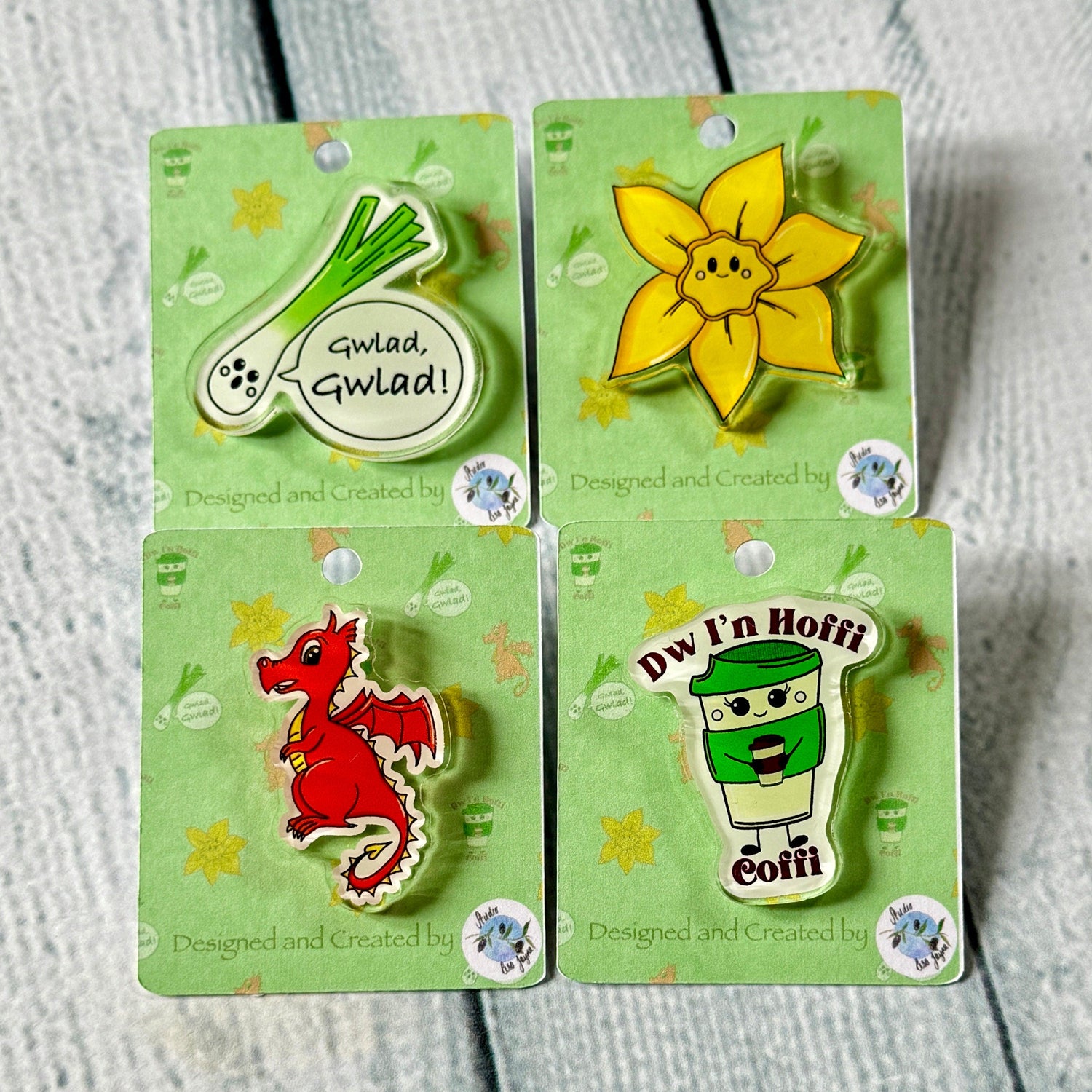 Welsh Pins including a Dragon, Daffodil, Leak singing Gwlad and Dw'in hoffi coffi