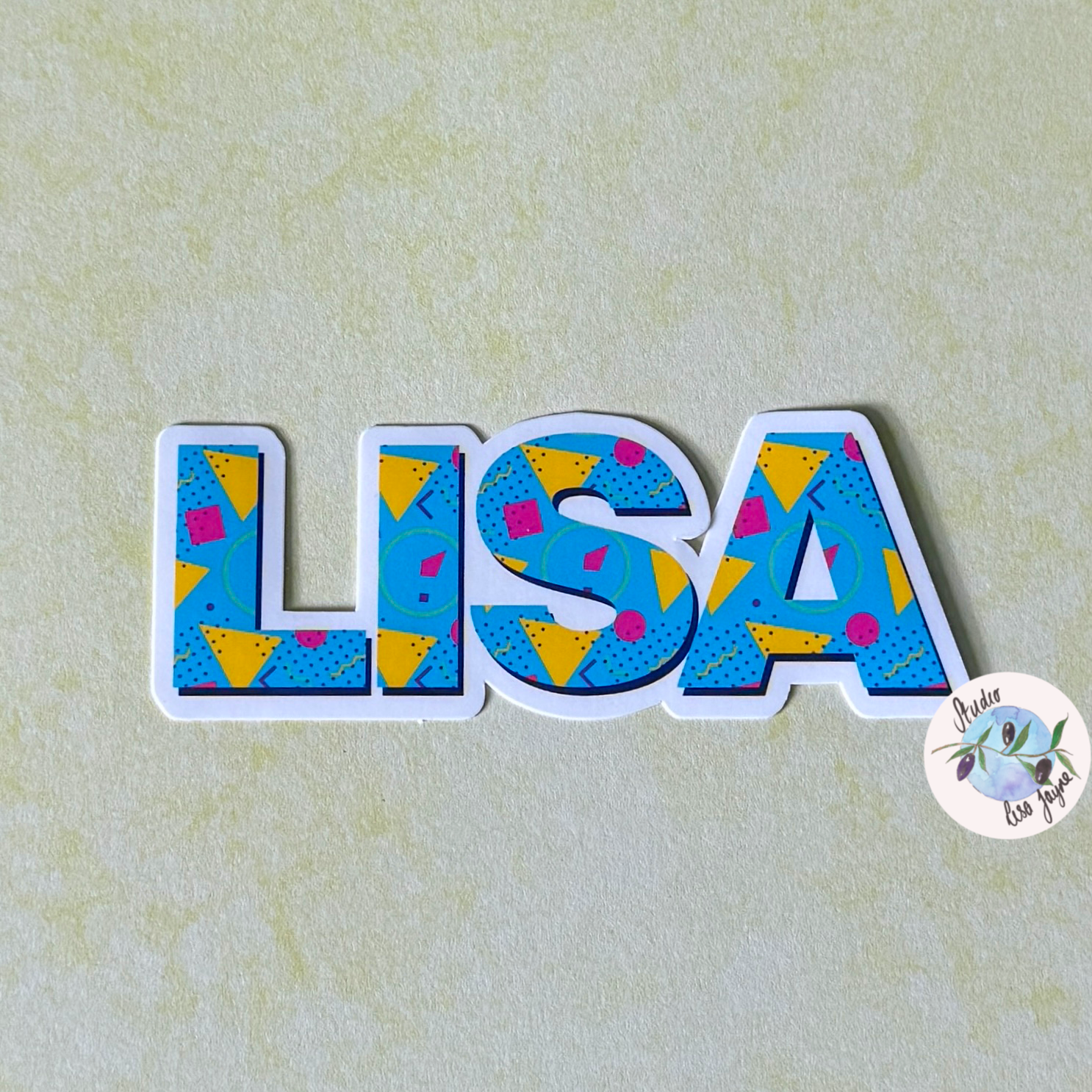 80s Style Personalised Waterproof Vinyl Name Sticker Patterned Geometric Retro Closeup on Lisa name label