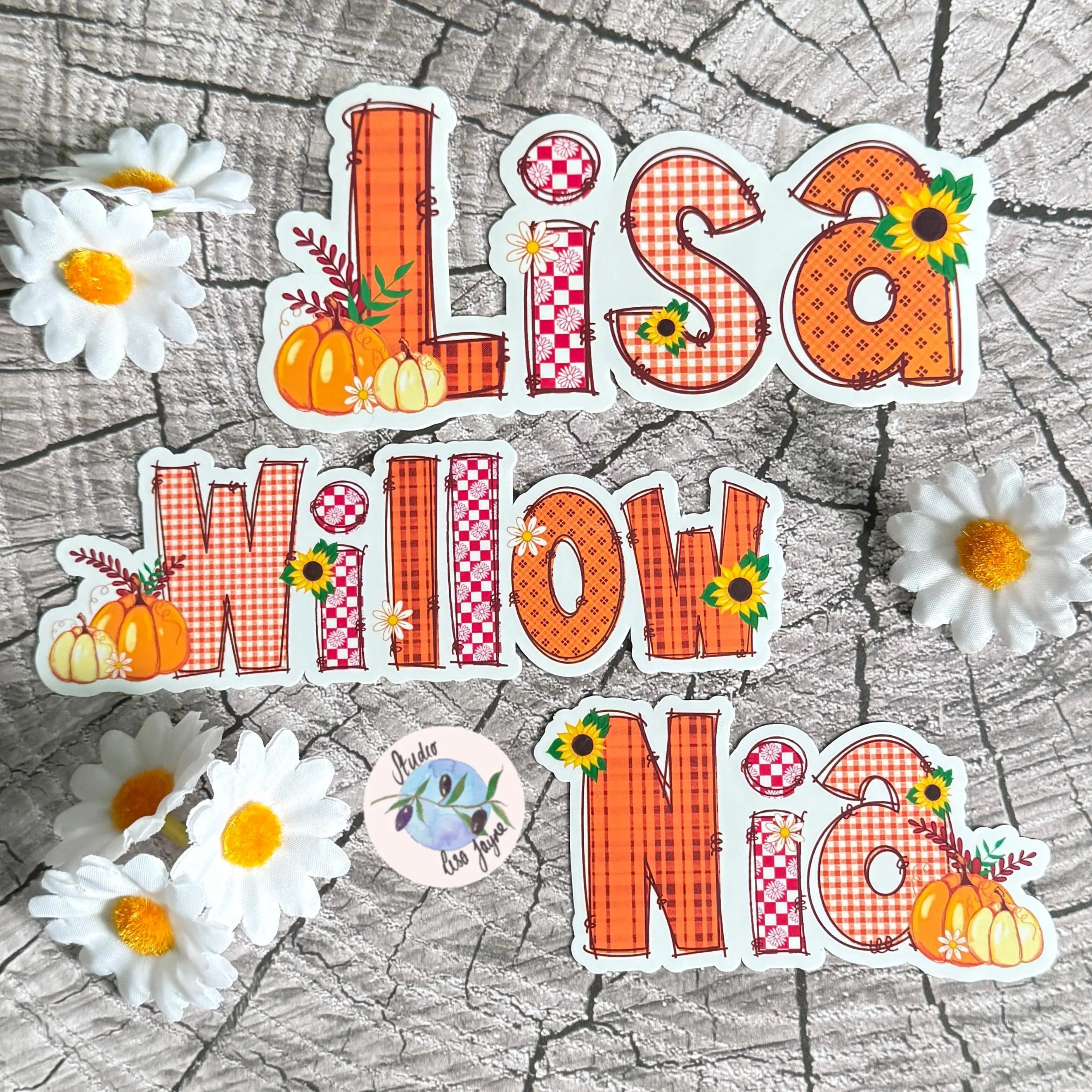 Sticker set with names 'Lisa', 'Willow', and 'Nia' in an autumn, fall, pumpkin theme on a wooden background with flowers.