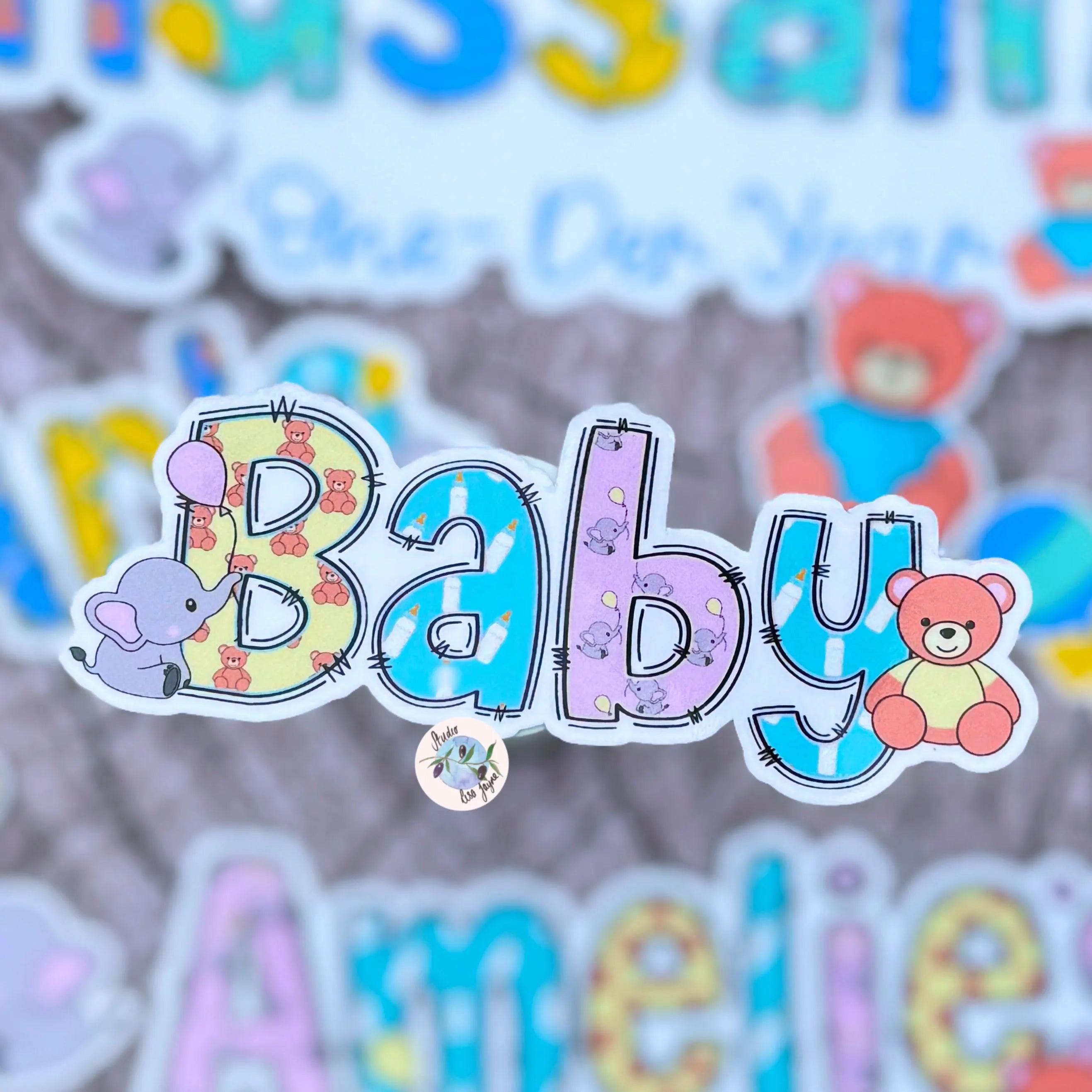 Colorful 'Baby' sticker with cartoon animals on a textured background.  Ideal for Memory Box
