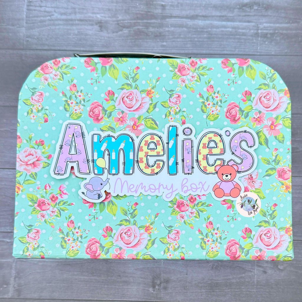 Floral-patterned keepsake chest with 'Amelies' and 'memory box' text with a new baby theme and a teddy and elephant with a baloon