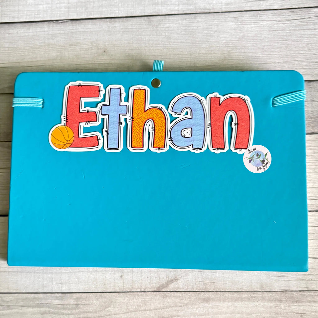 Basketball name sticker in the name 'Ethan' on a blue diary/notebook