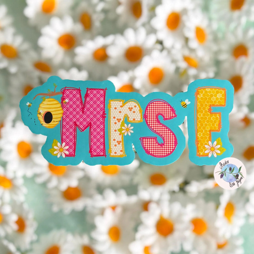 Decorative Teacher name sticker with 'MRS F' on a floral background