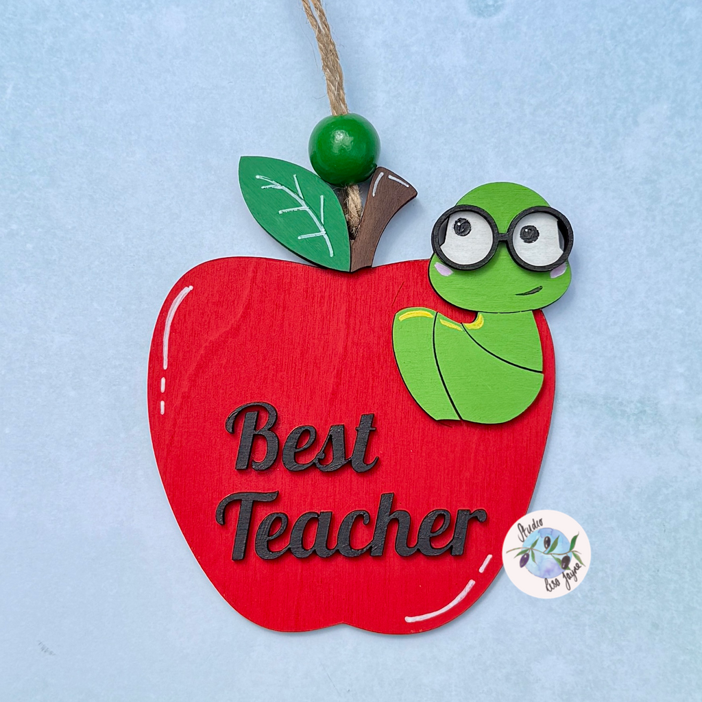 Best Teacher Apple End of Term Handmade Hanging Gift.  Layered plywood hand painted in red and green Thank You Teacher apple design

Simple blue background