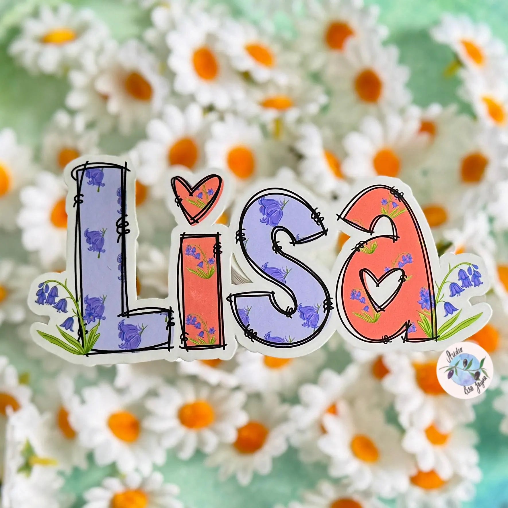 Colorful 'LISA' name sticker with floral Bluebell designs on a floral background.  Purple and Orange