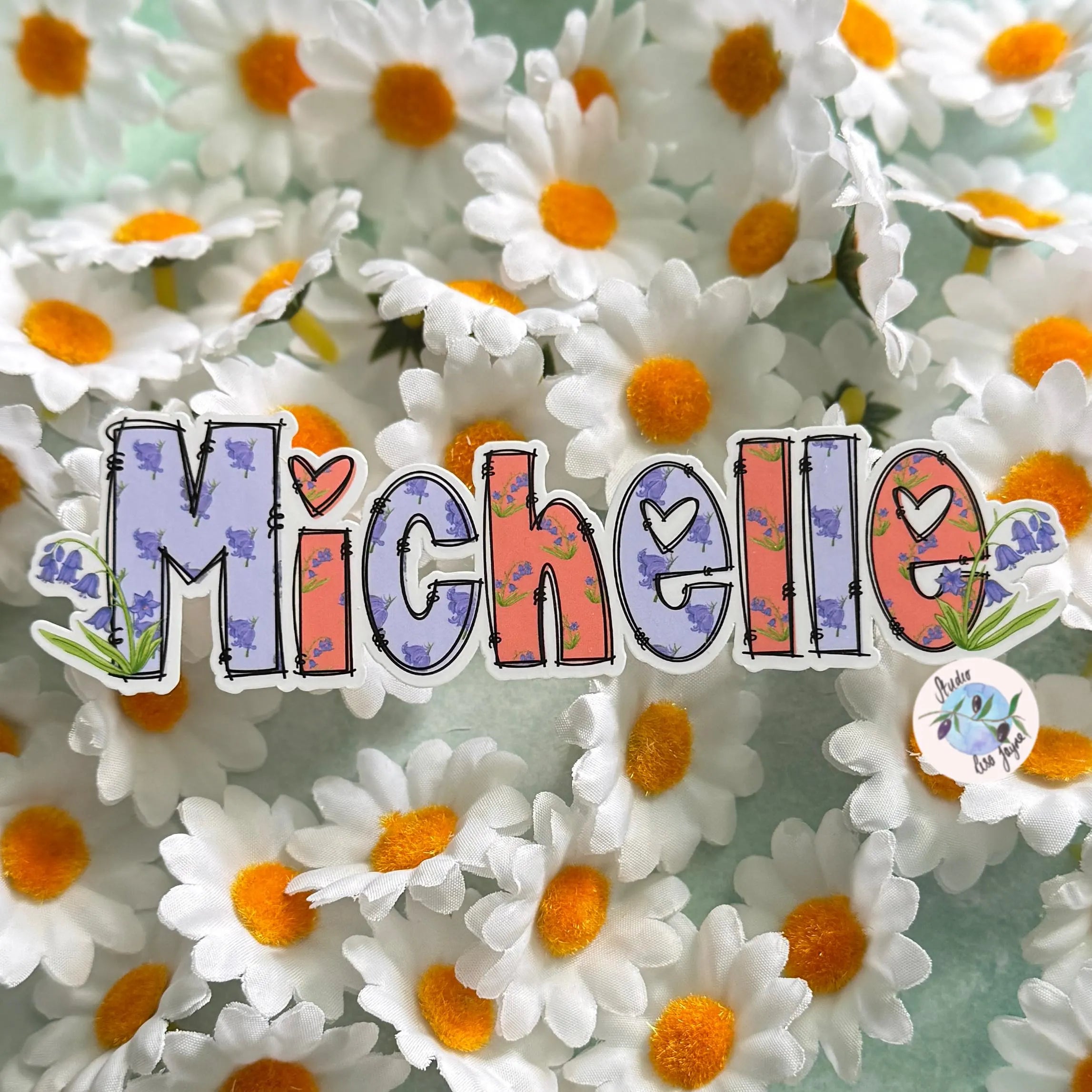 Bluebell Sticker with 'Michelle' surrounded by daisies on a light green background