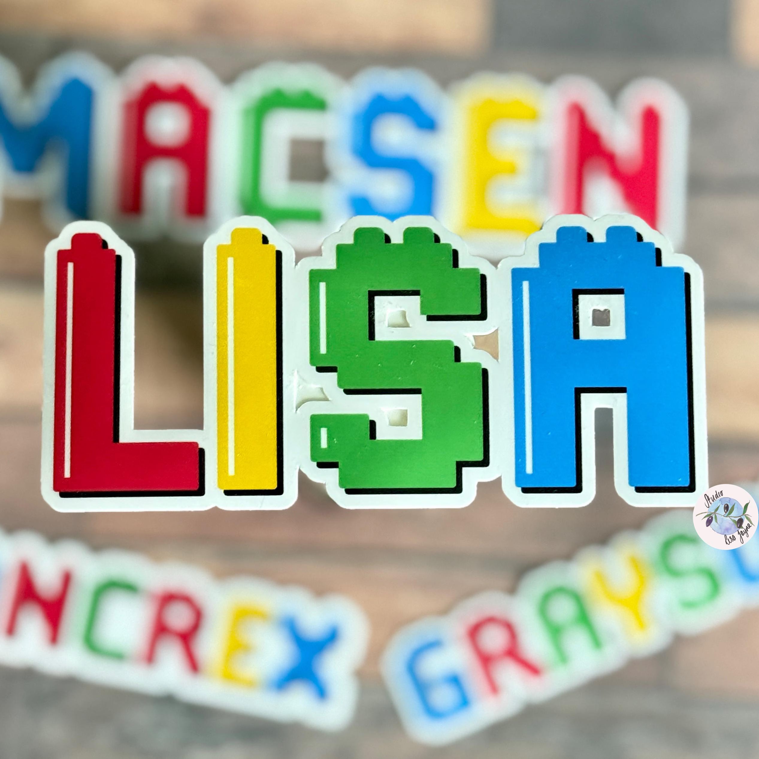 Colourful brick block name stickers on a wooden surface