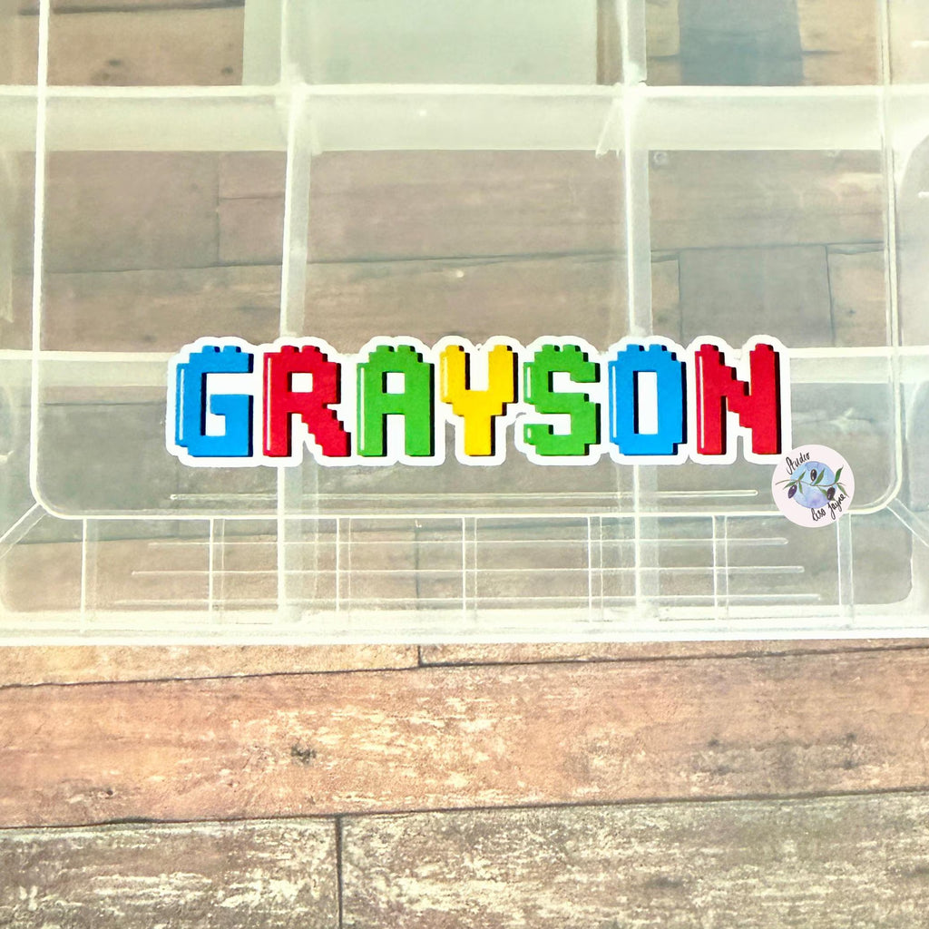 Colourful name 'GRAYSON' on a transparent container for storing sweets and other treats