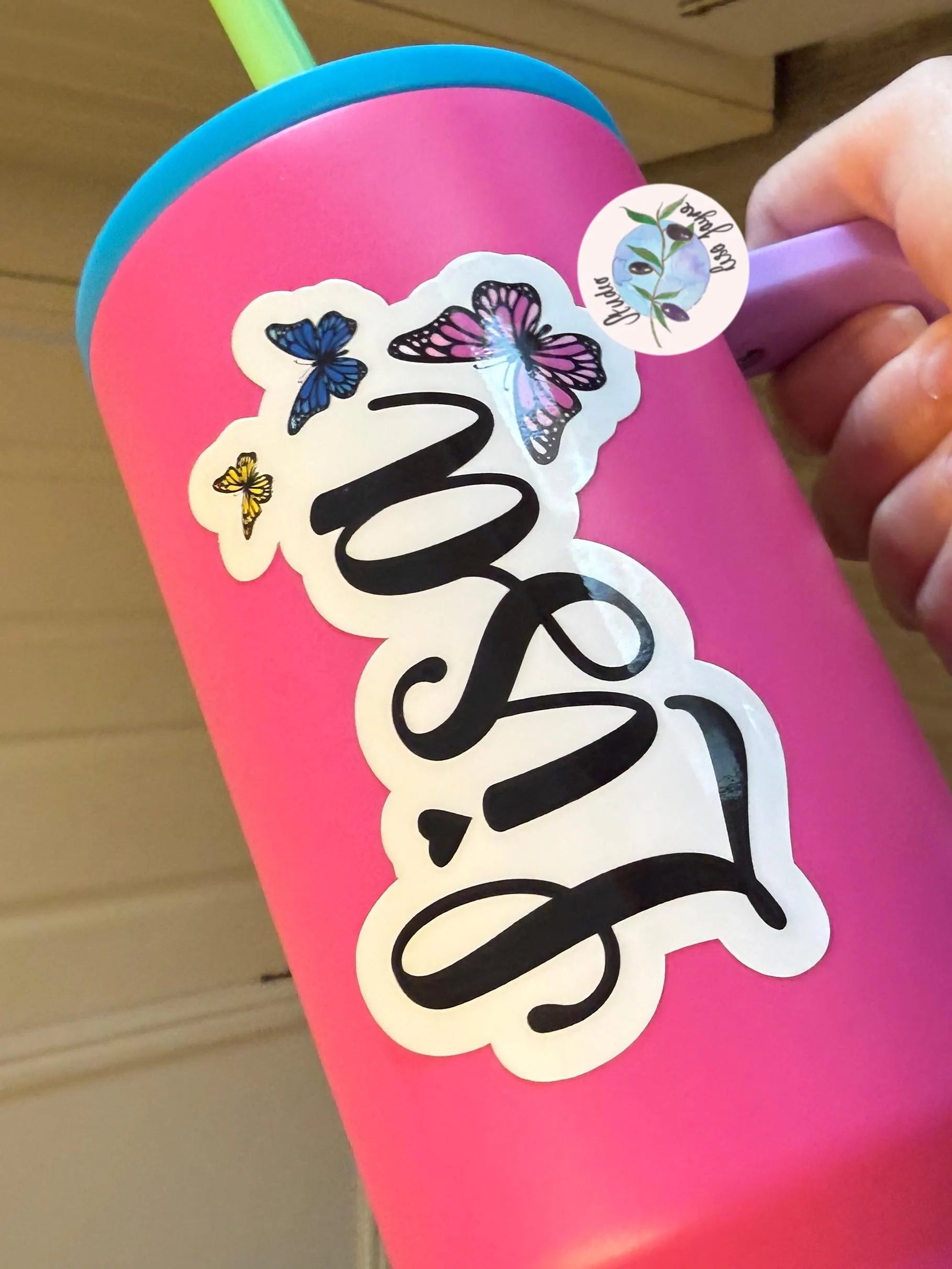Pink tumbler with 'Lisa' and colourful butterfly name sticker