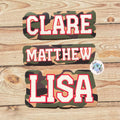 Camouflage name stickers with 'CLARE', 'MATTHEW', and 'LISA' on a wooden background