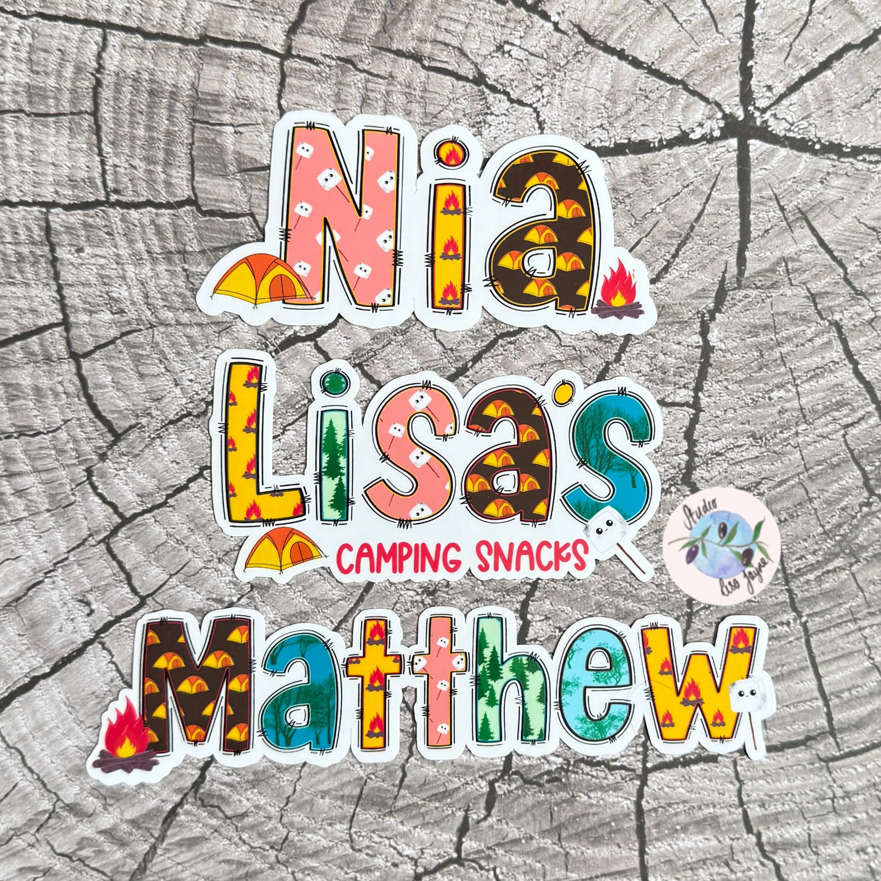 Colorful Camping text stickers on a tree bark background