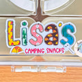 Clear compartmentalized container with 'Lisa's Camping Snacks' personalised camping label