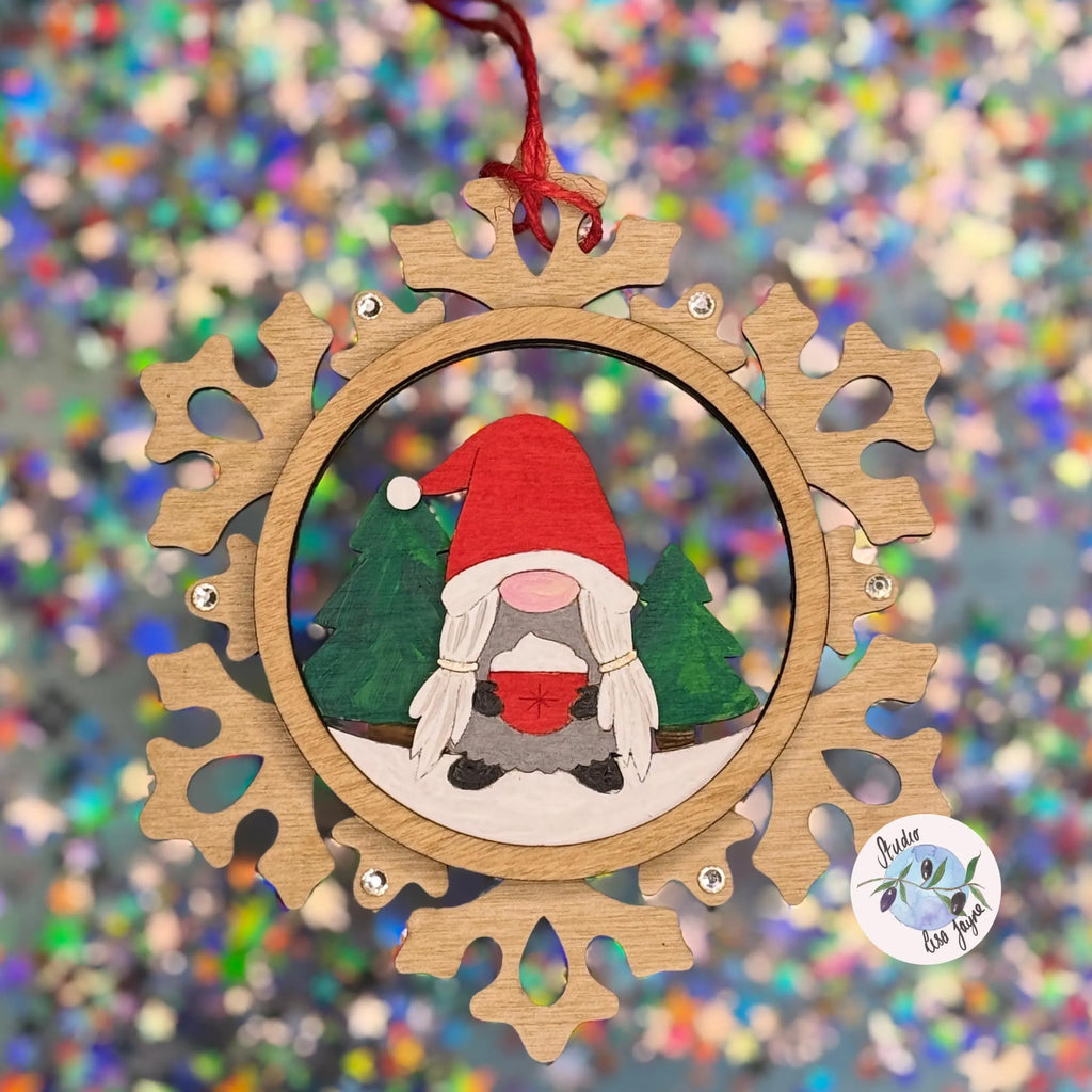 Wooden ornament with a cartoon gnome inside a snowflake frame on a colorful, blurred background.