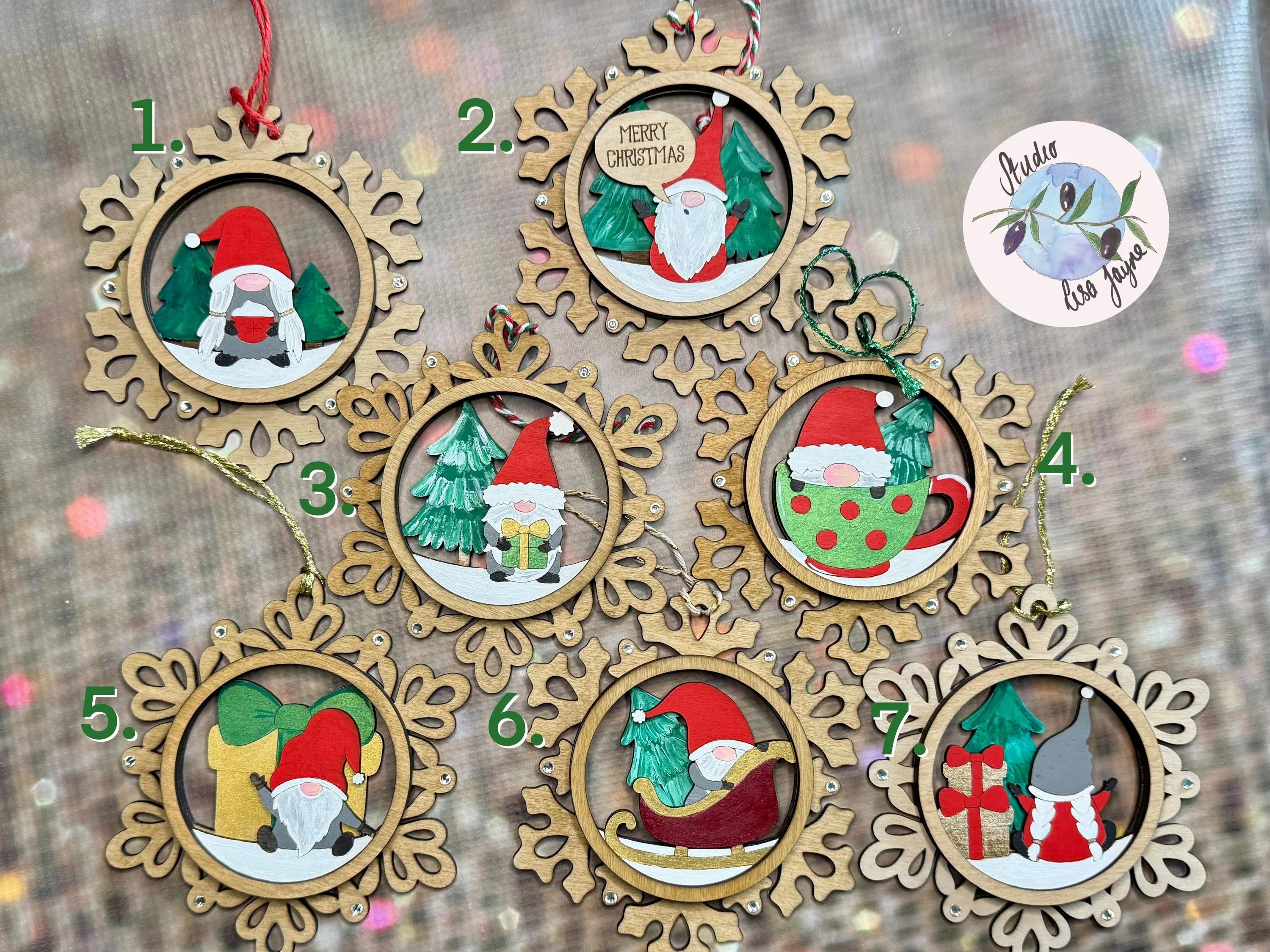 Wooden Christmas ornaments with Santa Claus designs on a wooden surface.