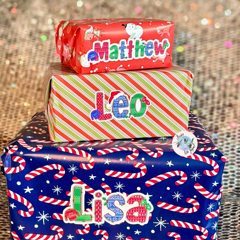 Stack of Christmas-themed gift boxes with personalized name stickers in a Christmas Jumper theme