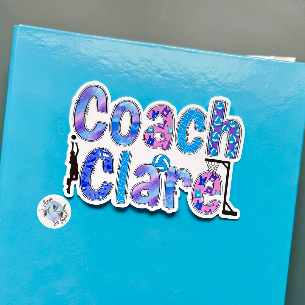 Blue notebook with 'Coach Clare' sticker on a gray background