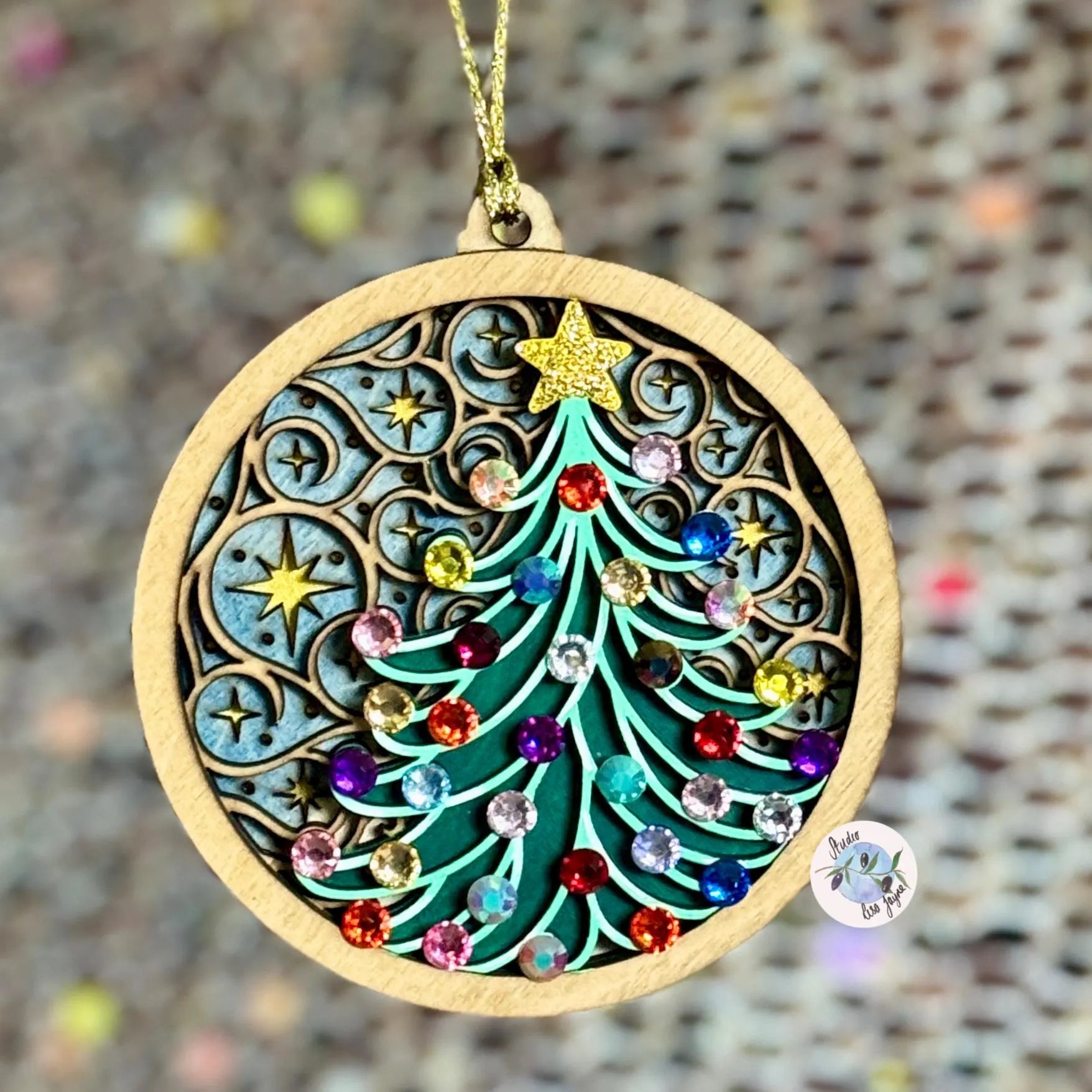 Decorative Christmas tree ornament with colorful crystals on a blurred background