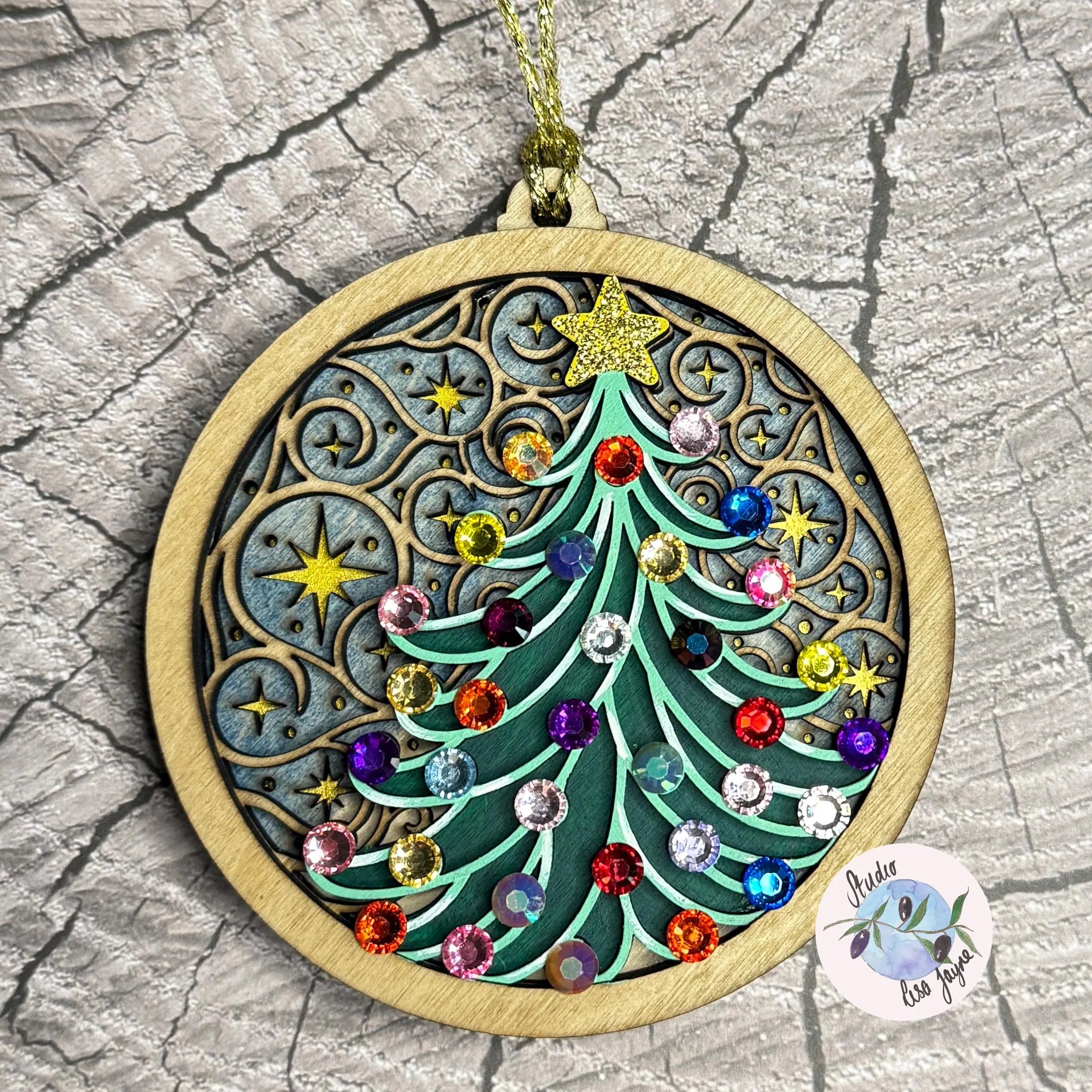 Handpainted Christmas tree ornament with colorful beads on a textured surface