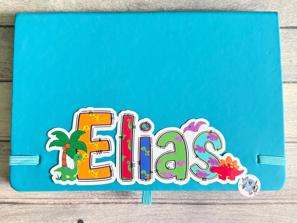 Blue notebook with colorful 'Elias' dinosaur sticker design 