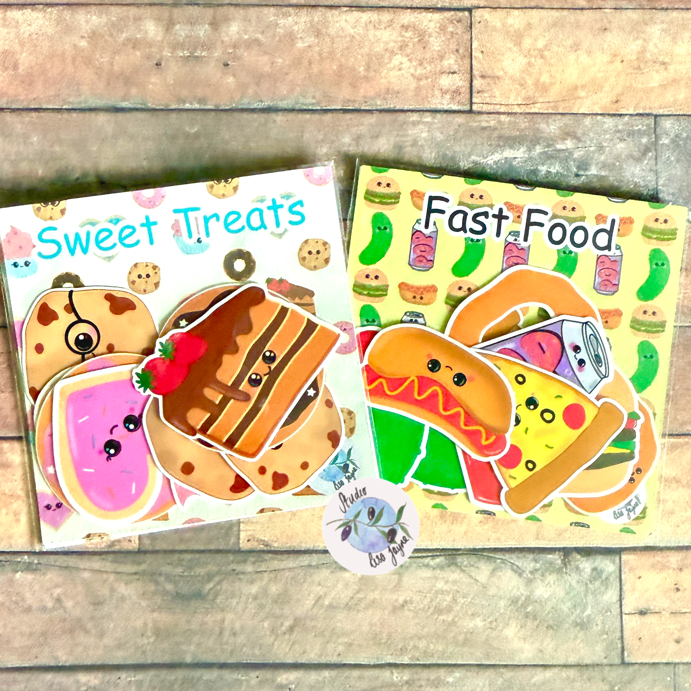 Two sticker sheets titled 'Sweet Treats' and 'Fast Food' on a wooden surface.
