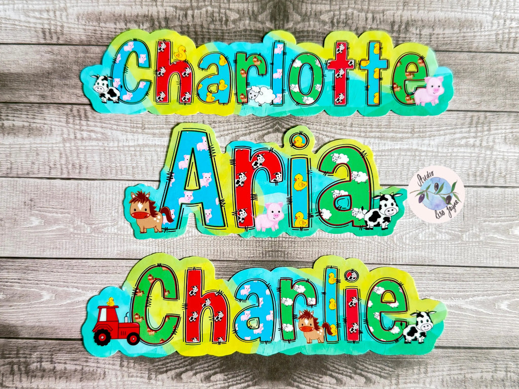 Colorful name decals with animal farm patterns on a wooden background