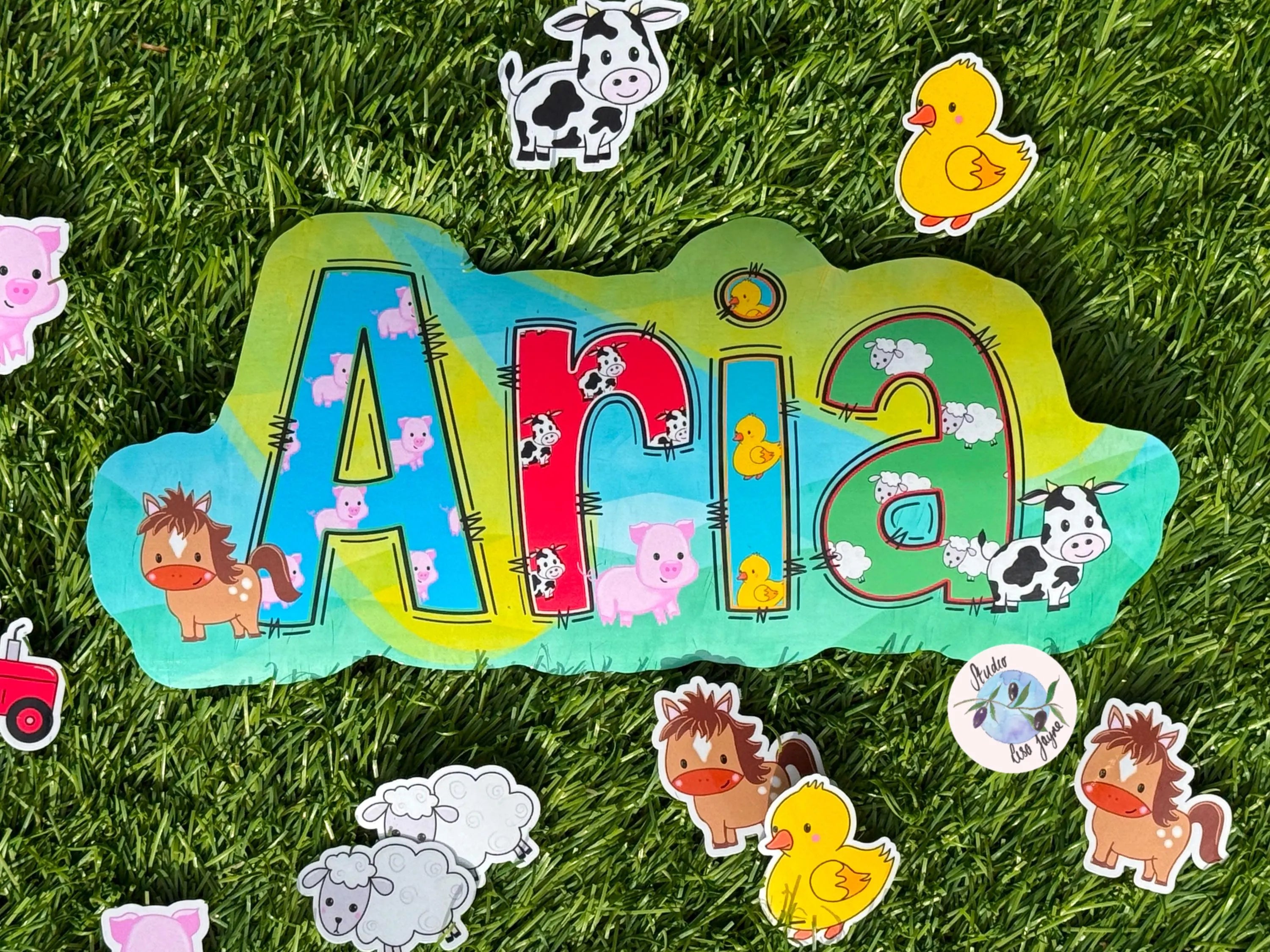 Decorative name sticker with cartoon farm animals on grassy backdrop