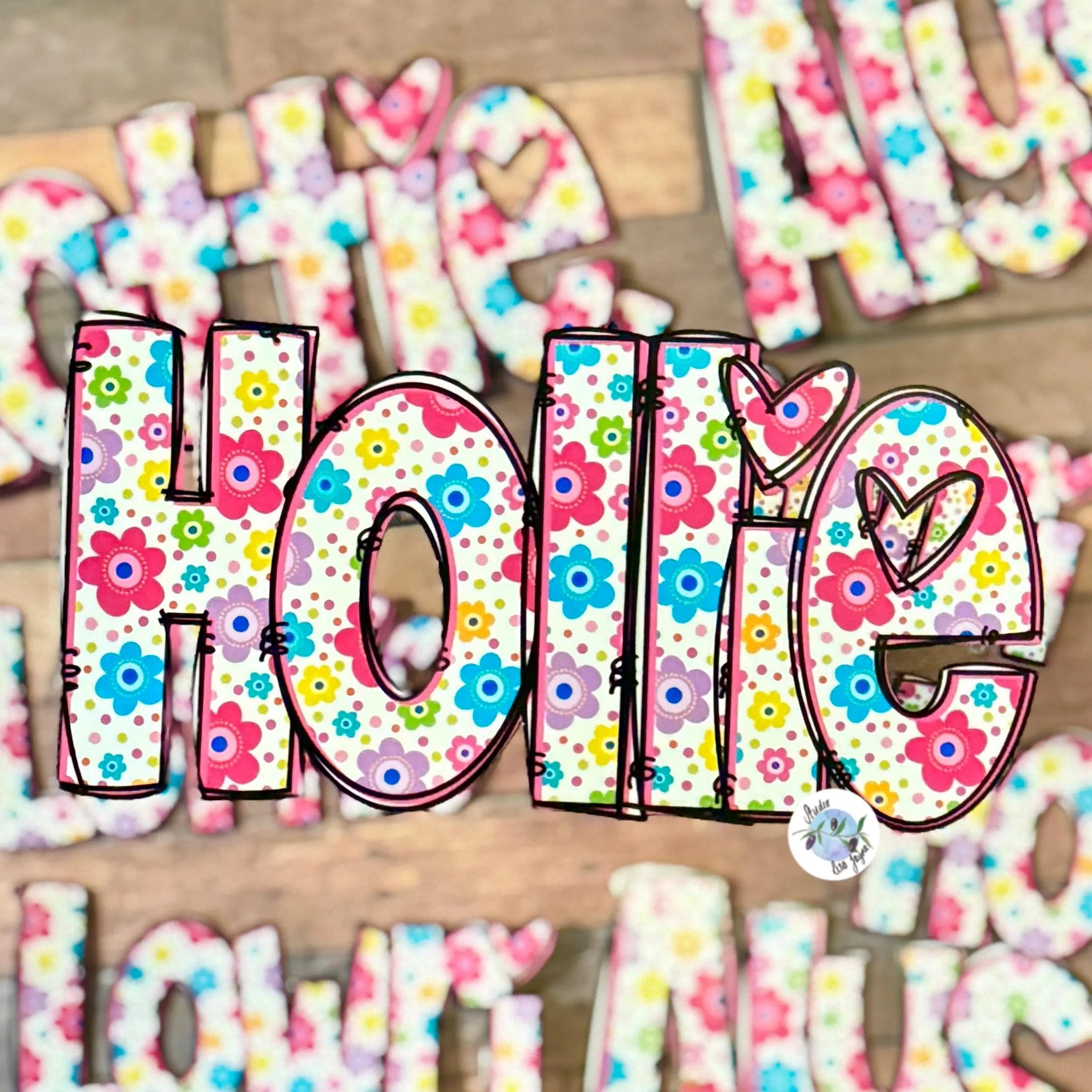 Colourful floral-patterned letters spelling 'Hollie' on a vinyl personalised feminine name sticker