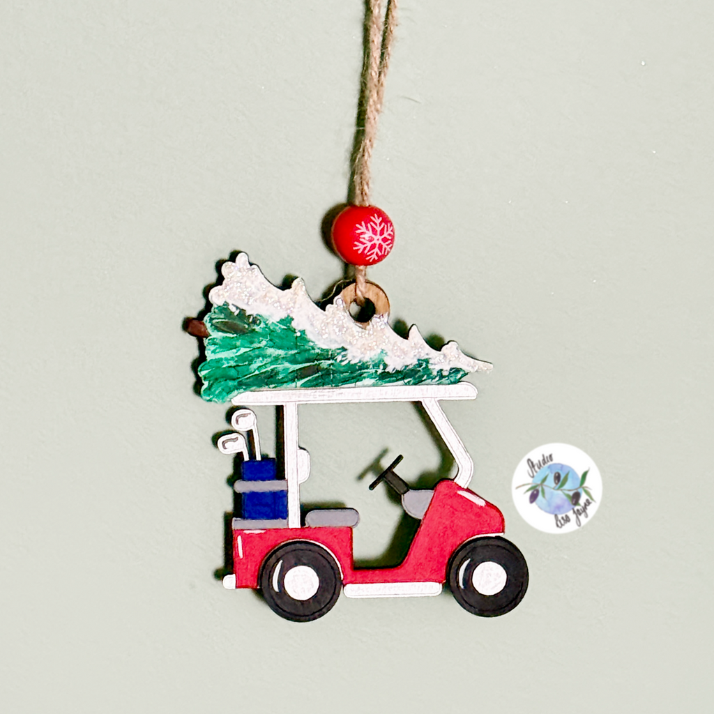 Decorative christmas ornament of a red golf cart with a green christmas tree on a gray background.  Driving Home for Christmas