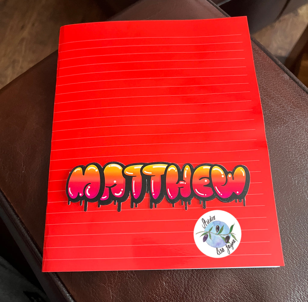 Red and orange graffiti school name label on school book