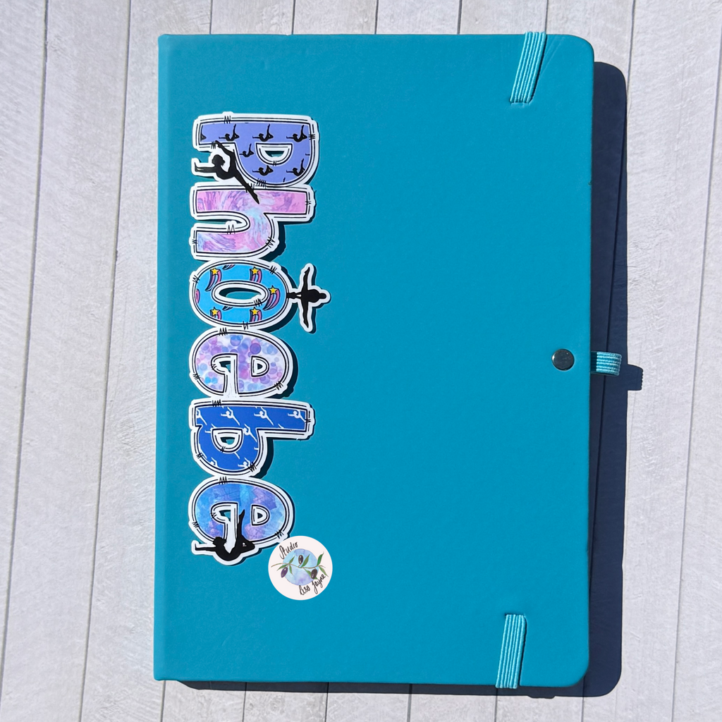 Gymnastics Name Sticker Applied to a notebook.  Waterproof personalised sports label for diary journal