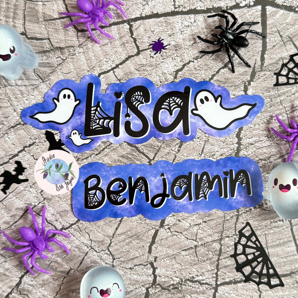 Purple halloween-themed stickers with 'Lisa Benjamin' on spider web and ghost 