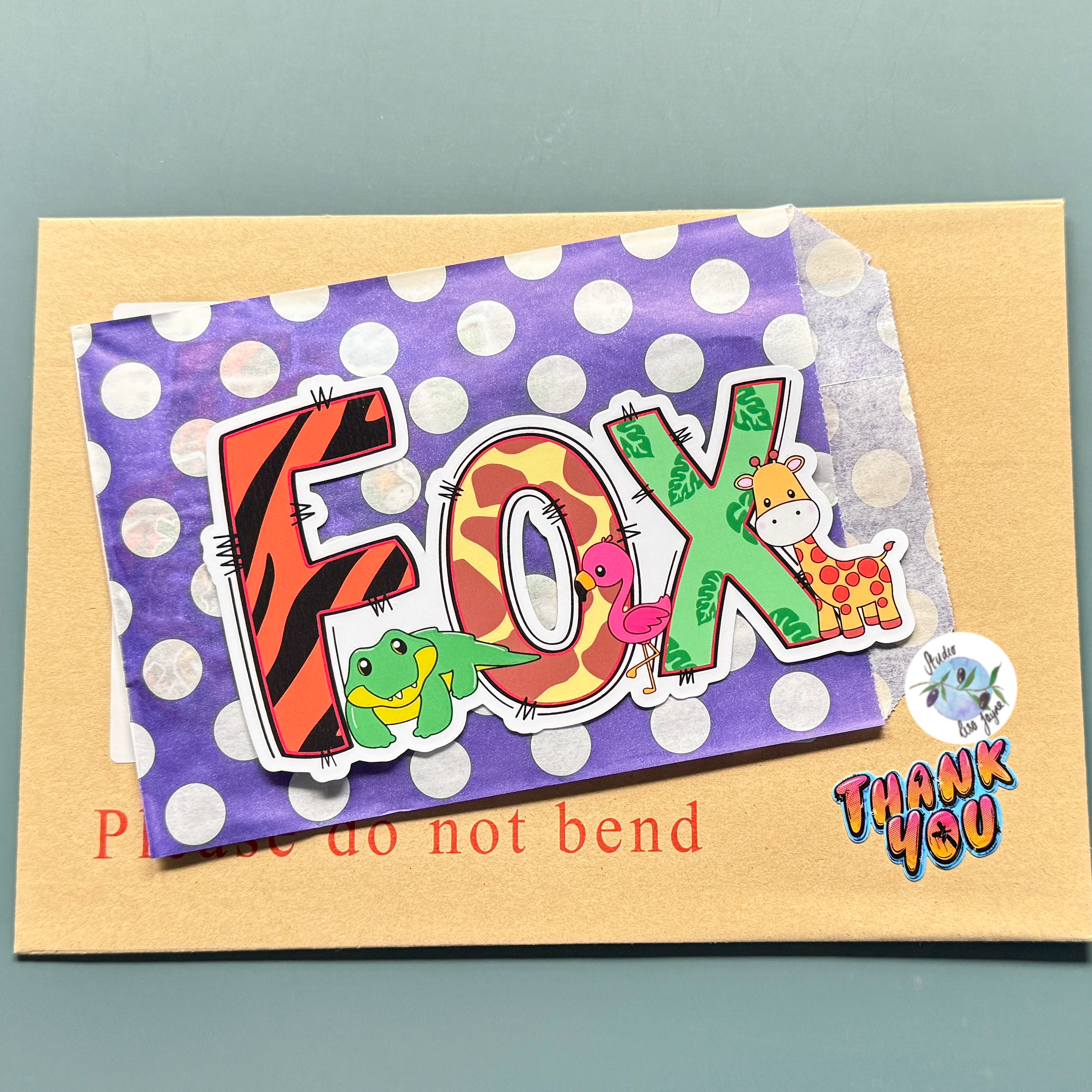 The name fox in a vinyl personalised name sticker with the theme of zoo animals.  Contains a crocodile, flamingo and giraffe 