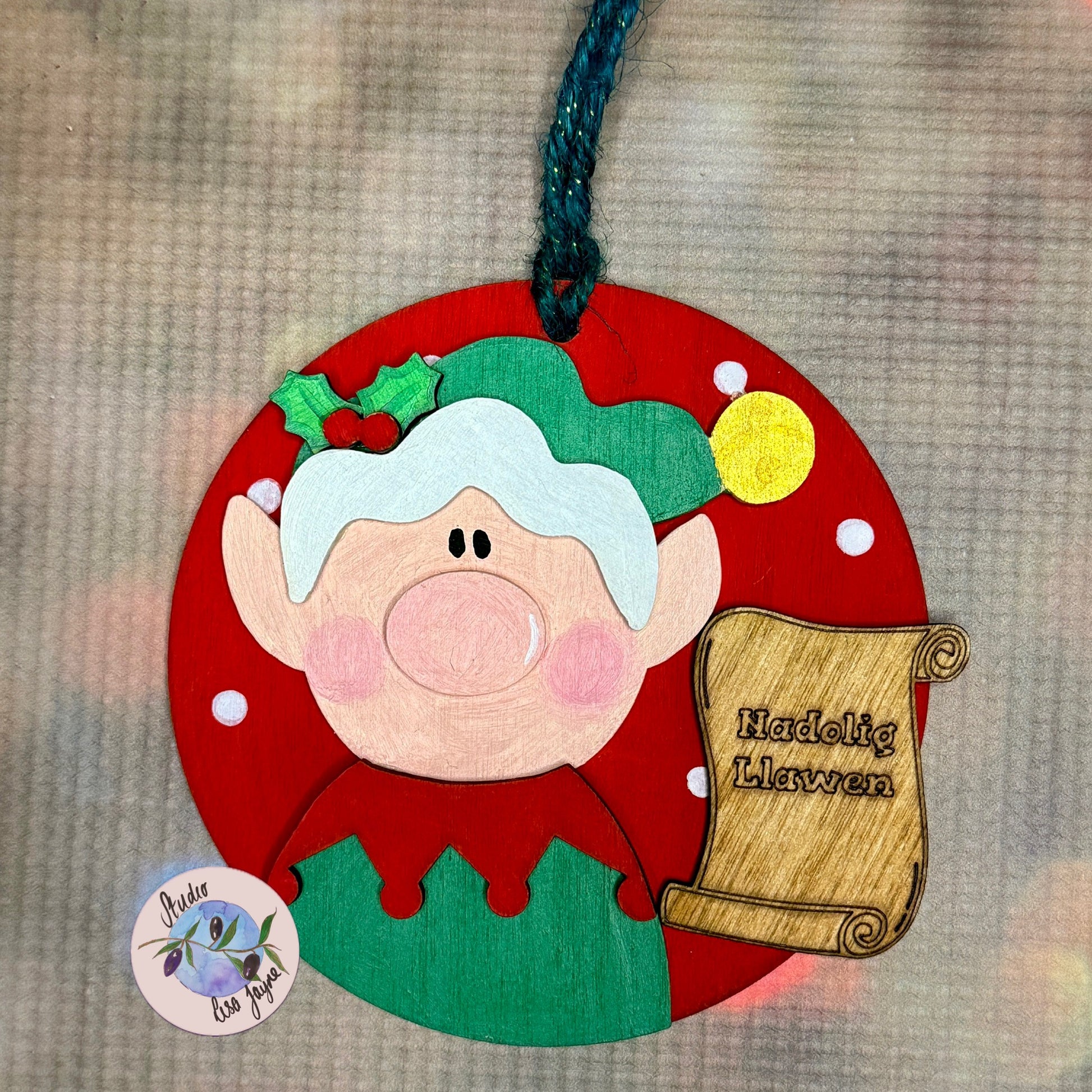 Nadolig Llawen Elf Christmas Tree Decoration Handmade Wooden Decoration Made in Wales - Green Elf on Red Backdrop