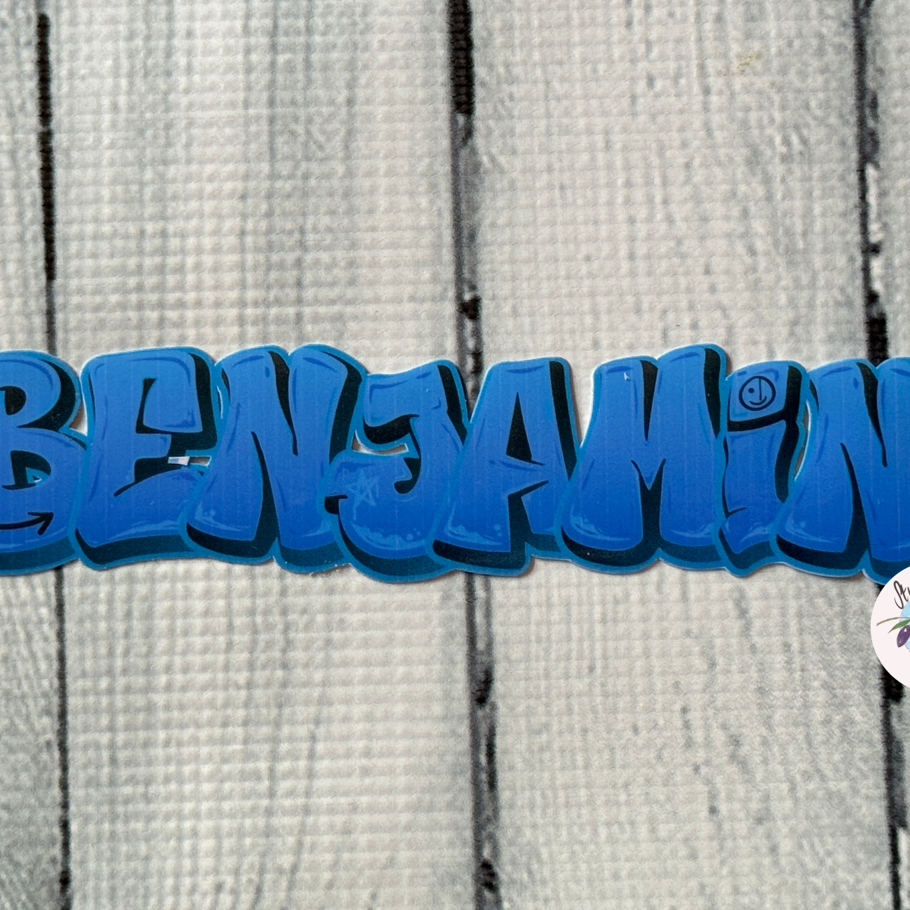 Navy blue night sky graffiti name sticker on a whitewash wood backdrop