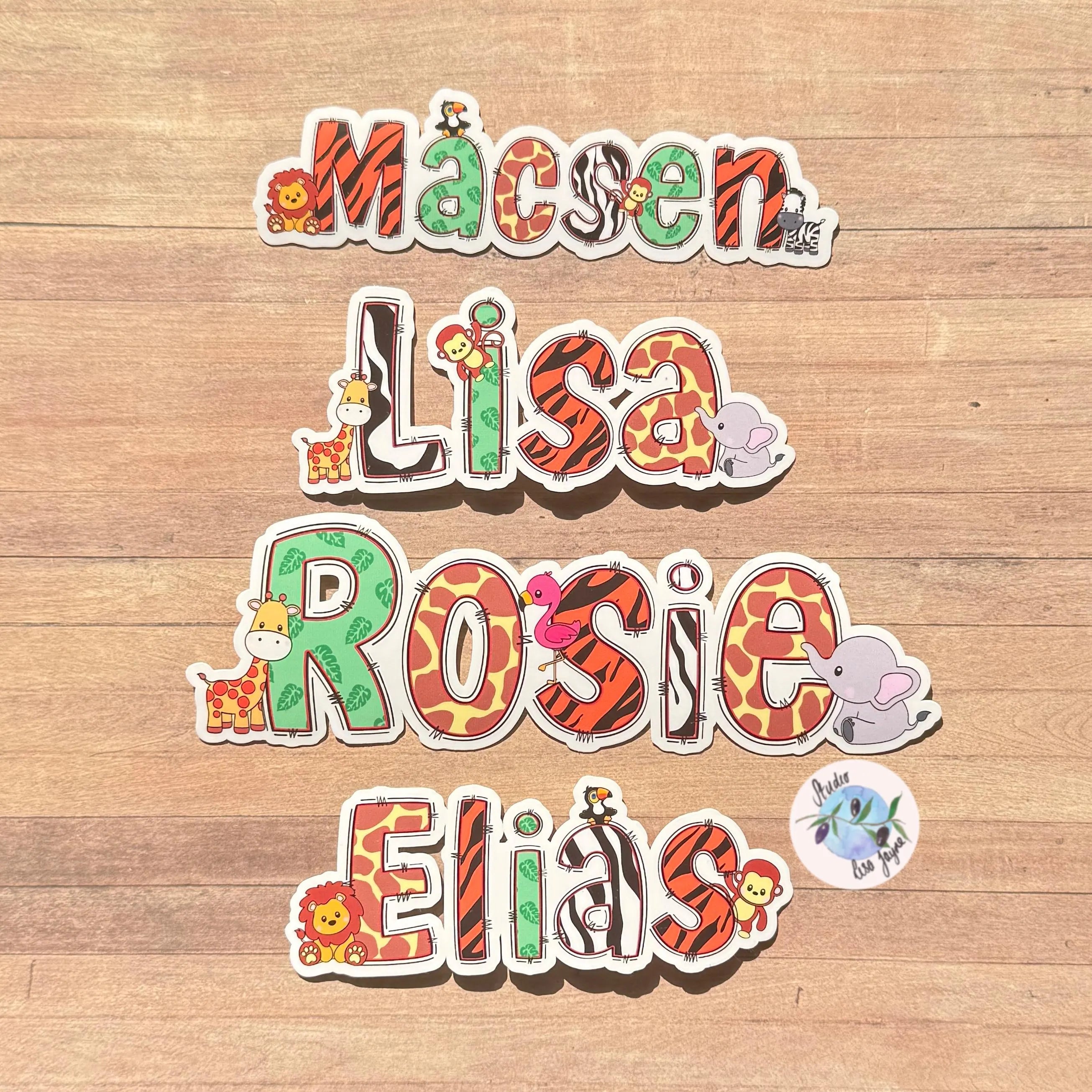 Colorful name stickers with animal designs on a zoo design sticker on a wooden background