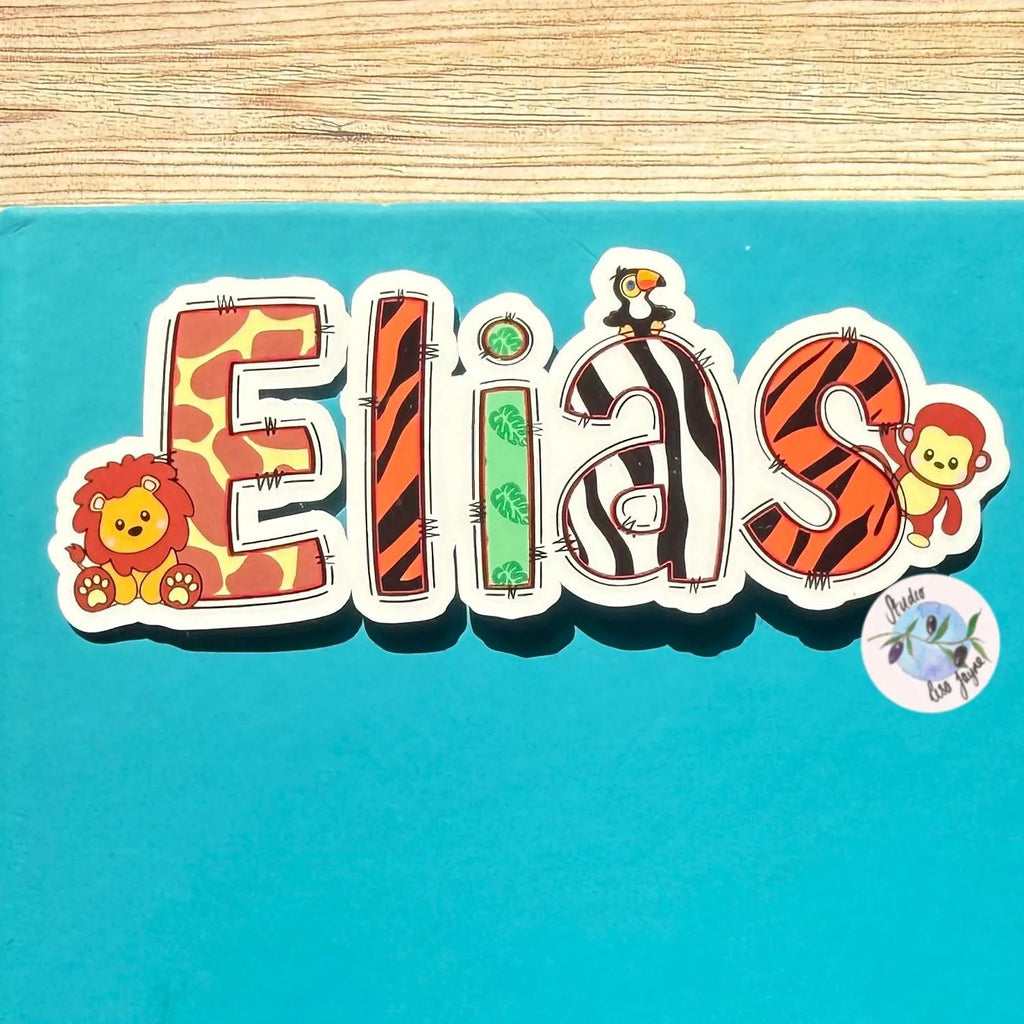 Colorful name 'Elias' with animal-themed name sticker on a blue notebook