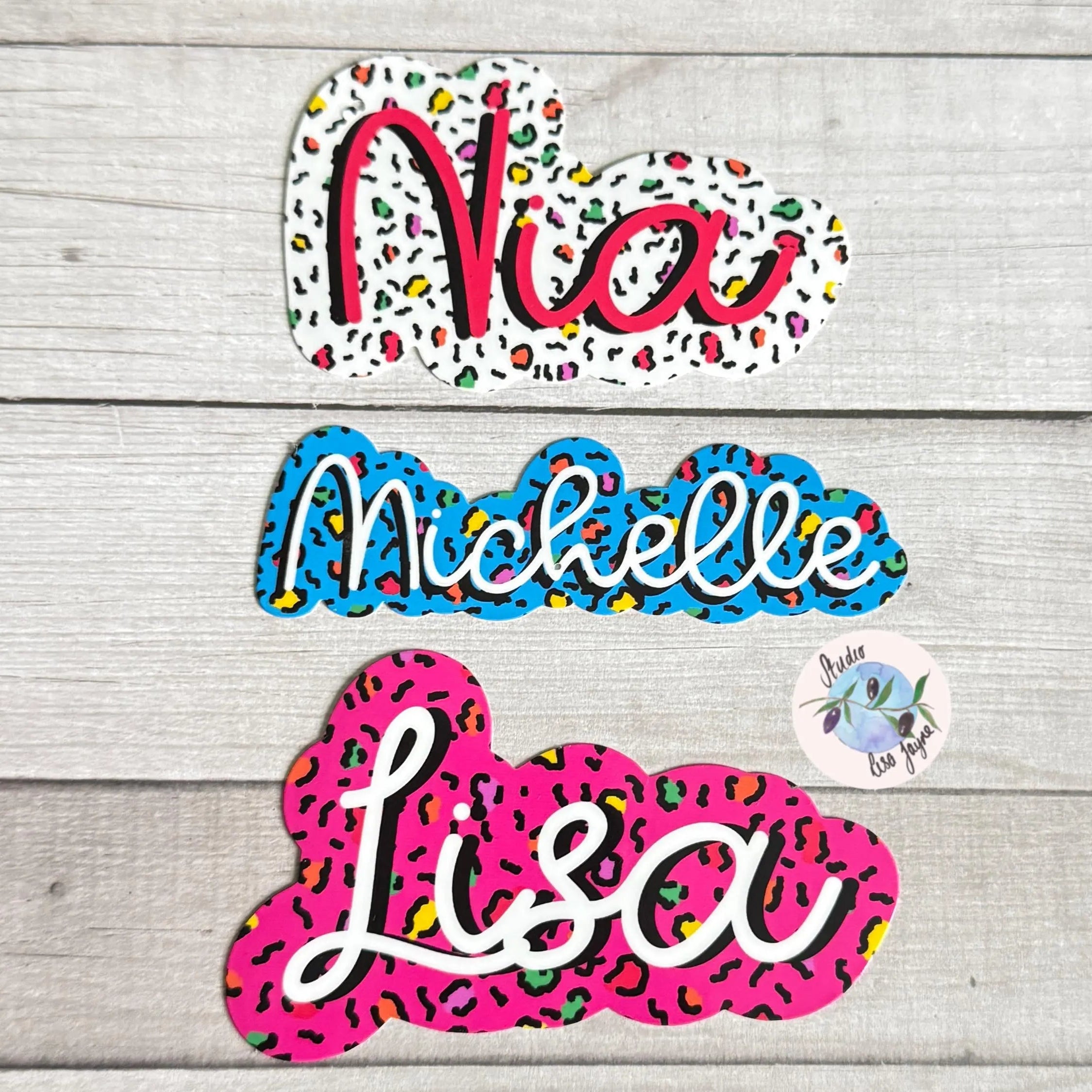 Colorful name leopard print stickers on a wooden surface