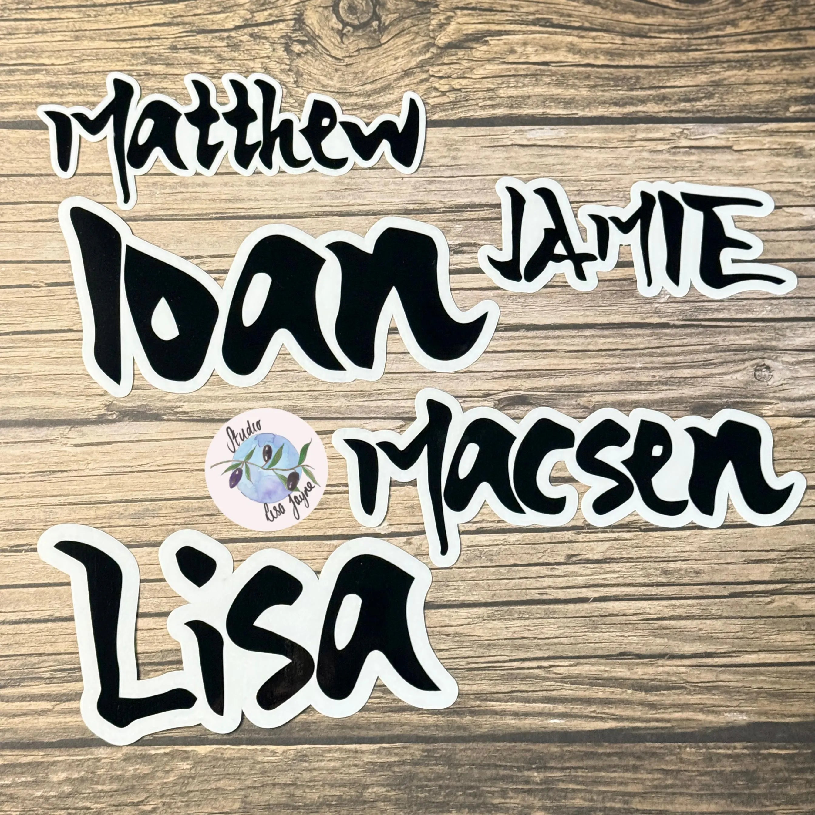 Set of personalized name stickers in a manga anime theme on a wooden background