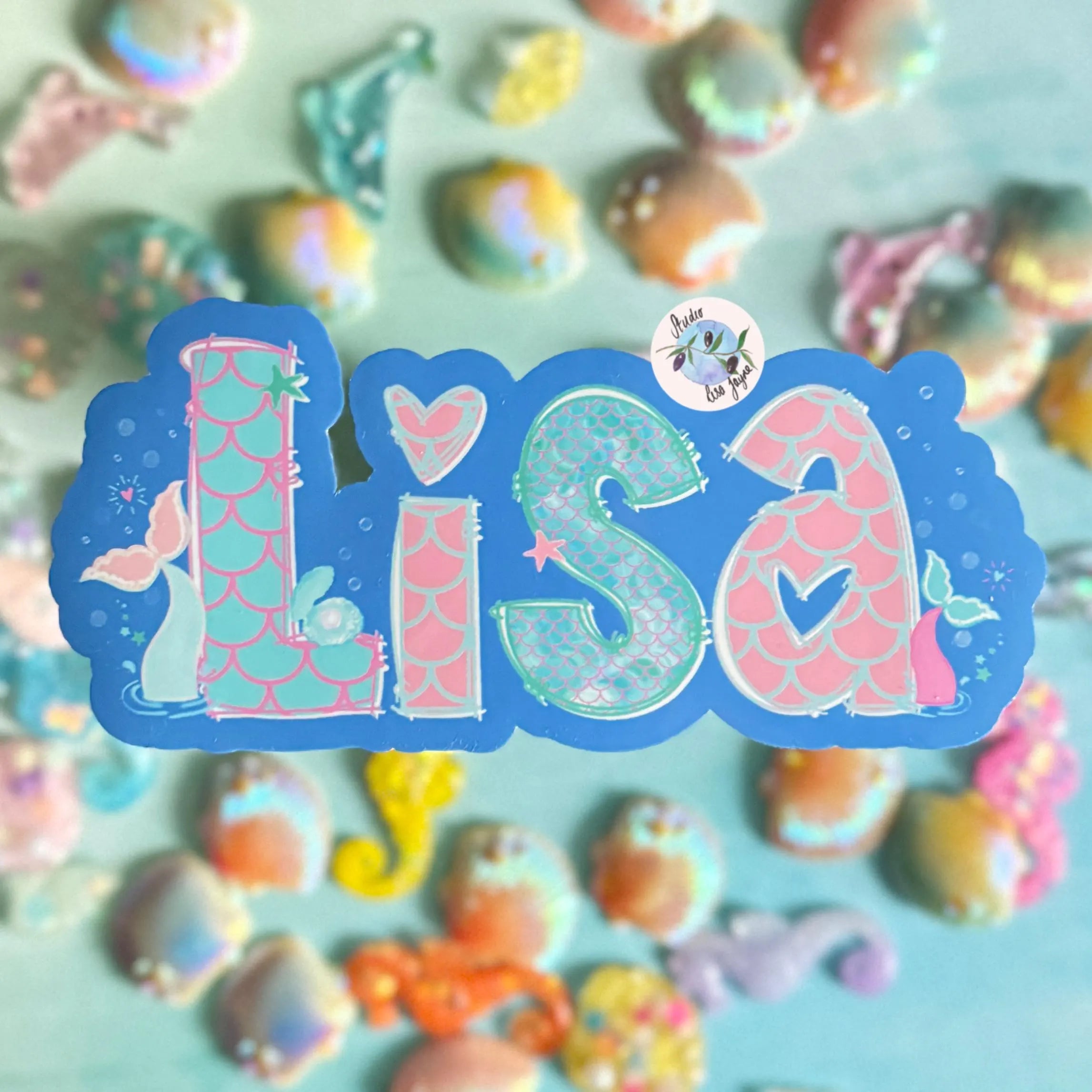 Sticker with the name 'Lisa' surrounded by mermaid-themed decorations and bubbles on a colorful background