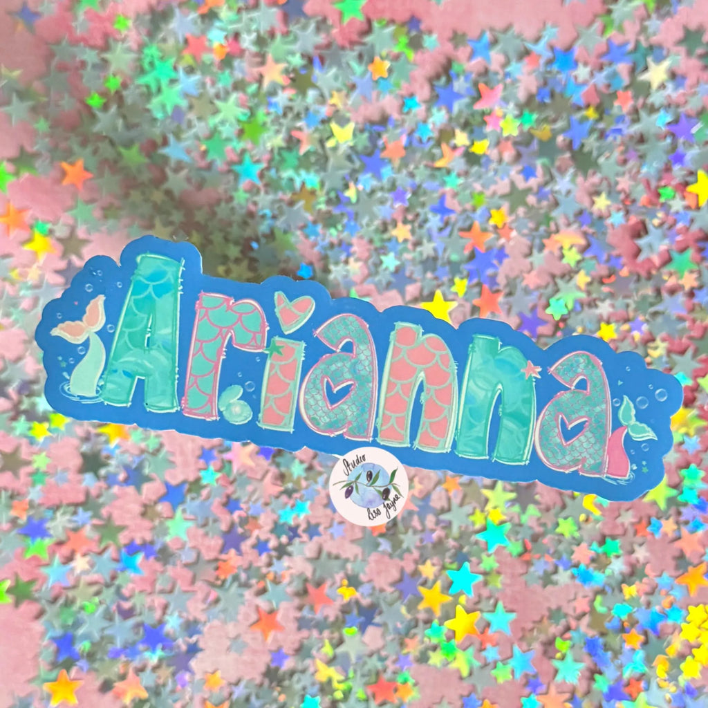 Colorful Mermaid 'Arianna' name decal with star confetti on a pink background.