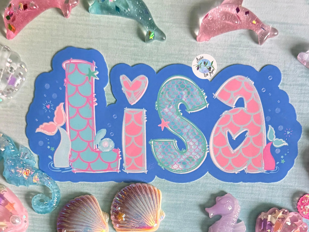 Decorative name decal with 'Lisa' surrounded by mermaid-themed decorations on a light blue background