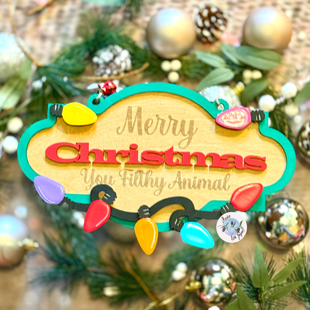 Decorative Christmas hanging sign with 'Merry Christmas You Filthy Animal' text on a tree.  Quote from the Movie Home Alone 2