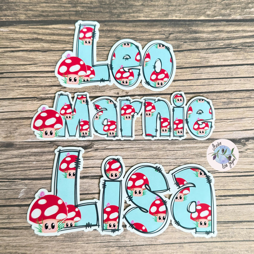 Stickers with cartoon mushrooms and names on a wooden surface