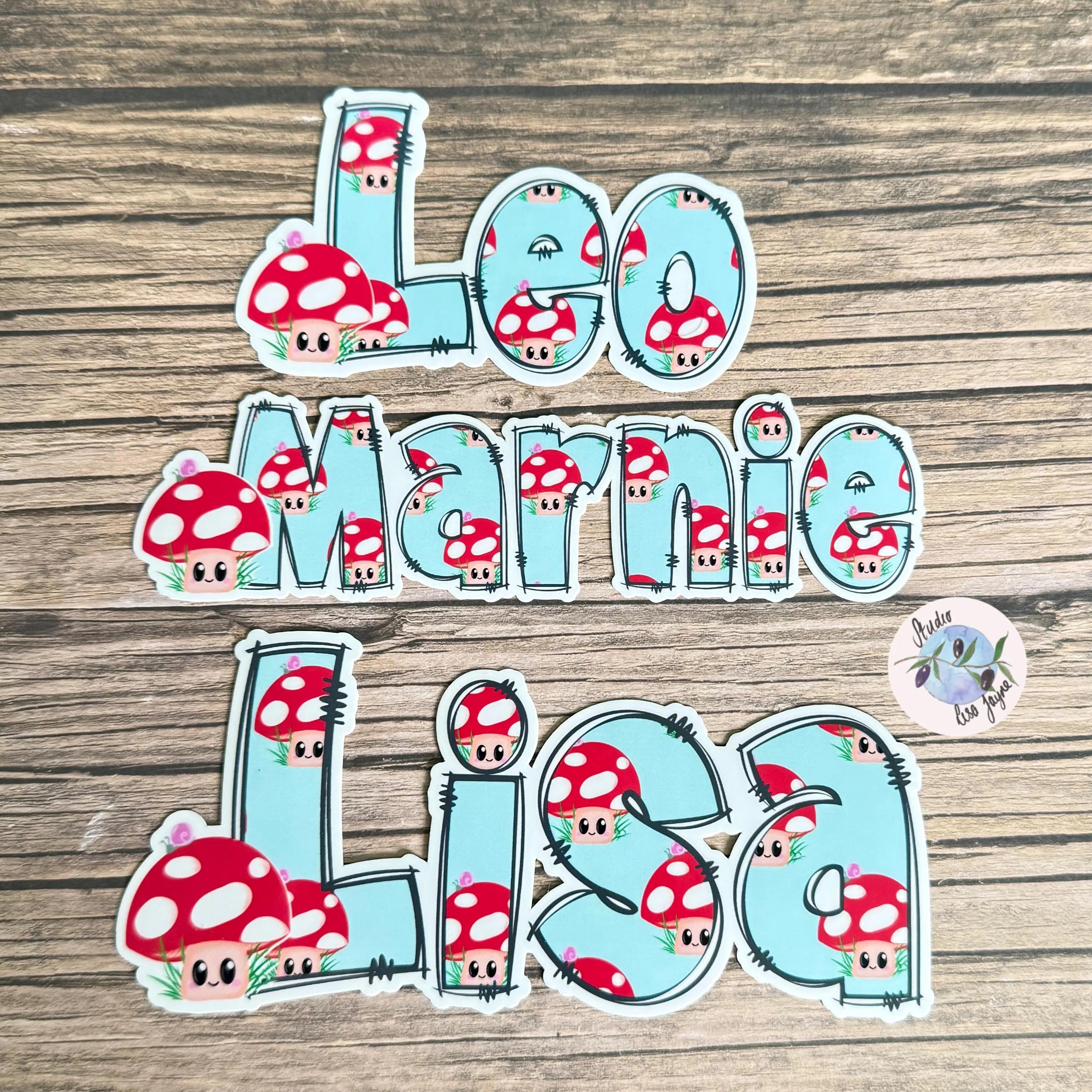 Stickers with cartoon mushrooms and names on a wooden surface