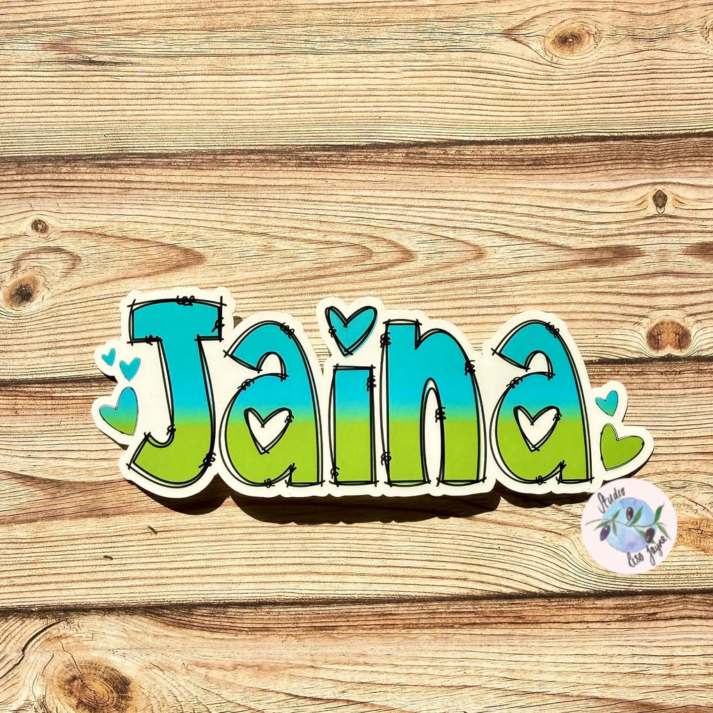 Ombré Heart Name Sticker with the name 'Jaina' on a wooden background