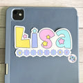 Personalized pastel star name sticker on an iPad tablet case 'Lisa Williams' text