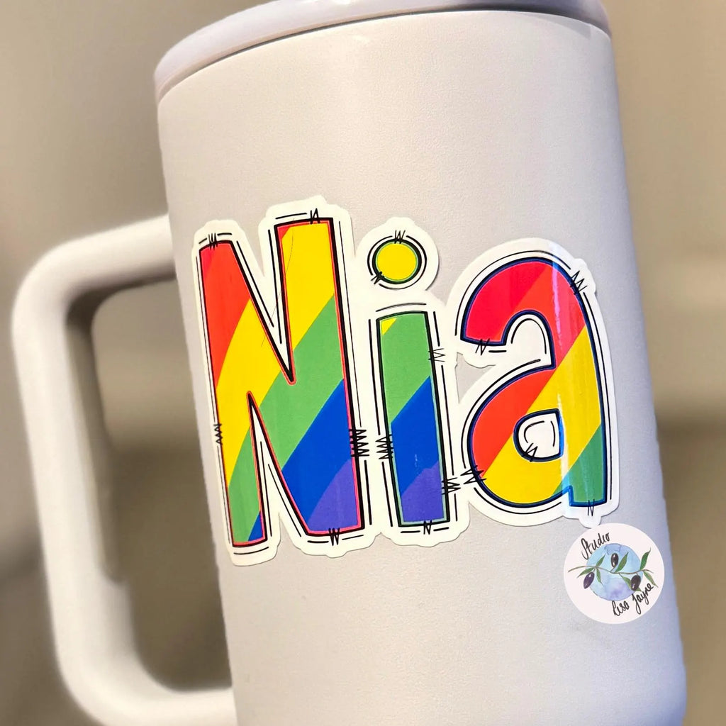 White water bottle with a rainbow-colored 'Nia' sticker on a neutral background